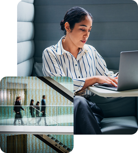 Team members having a collaborative discussion around a laptop in a modern conference room