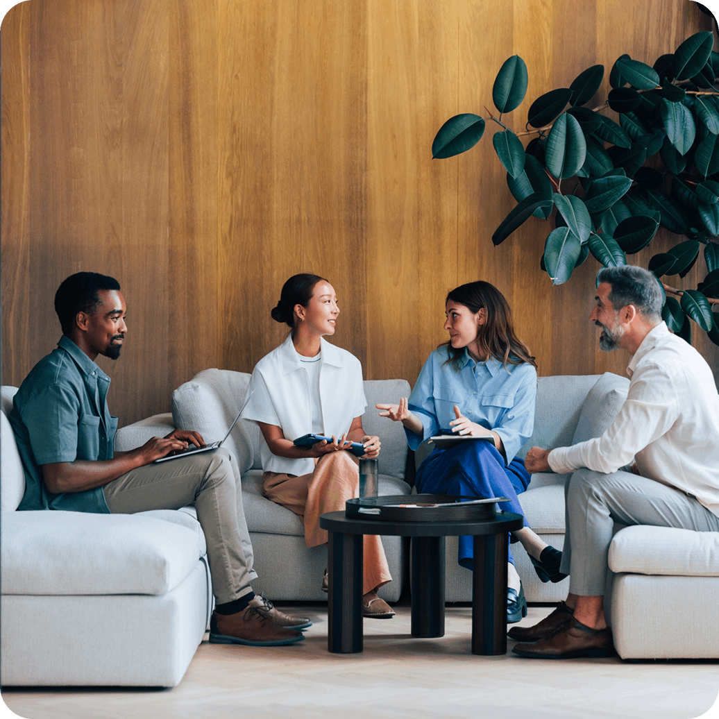 Modern office interior with employees working at open-plan desks Modern office interior with employees working at open-plan desks