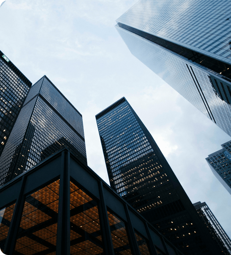 Modern high-rise corporate office skyscrapers viewed from a low angle against a clear blue sky
