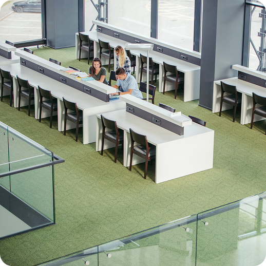 Modern corporate office interior showing spacious open desks and collaboration zones