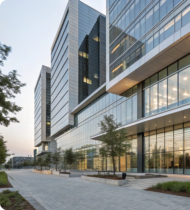 Exterior view of a modern multi story glass corporate office building on a clear day