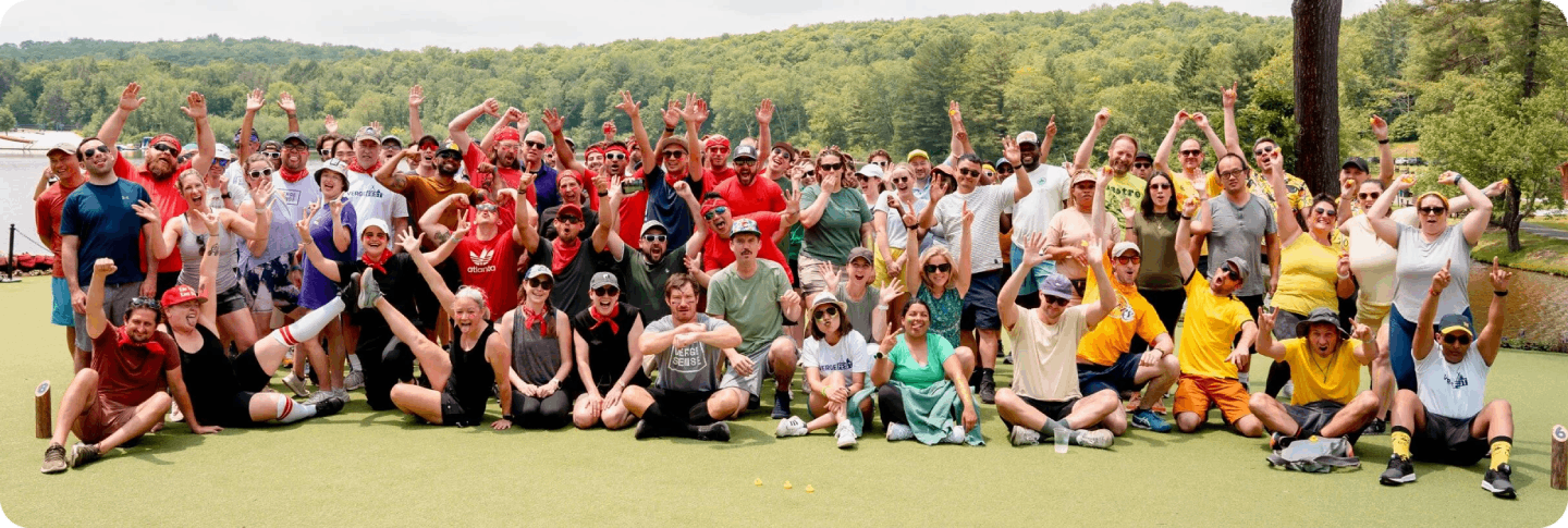 Group photo of the VergeSense team outdoors smiling and waving hands in a park setting Group photo of the VergeSense team outdoors smiling and waving hands in a park setting